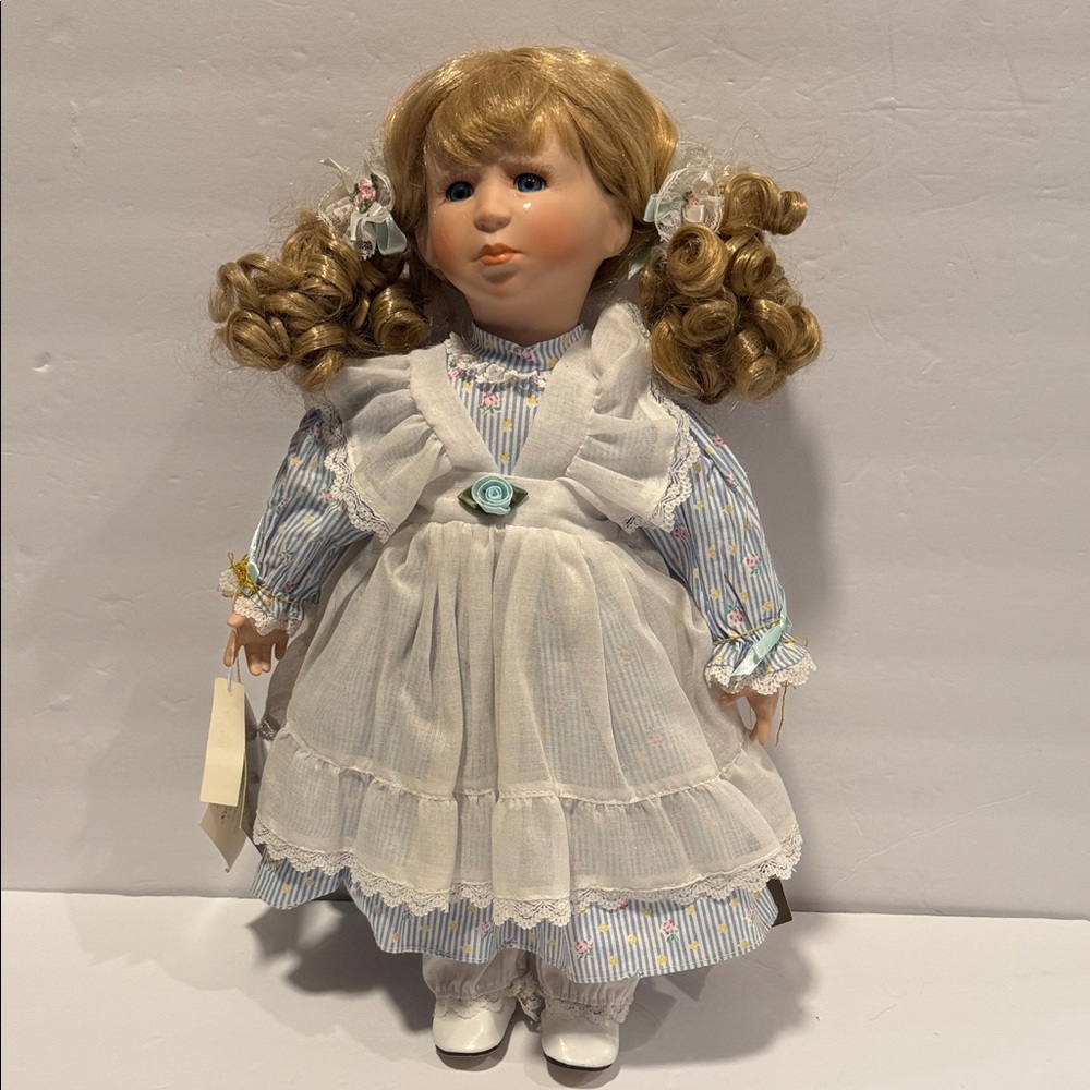 50.  Adorable Doll with Blonde Curls and White Dress.